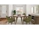 Staged dining area featuring a round wooden table and plenty of natural light at 8836 Waco Ct, Commerce City, CO 80022