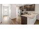 Modern kitchen with stainless steel appliances, dark cabinets, and an open layout at 8836 Waco Ct, Commerce City, CO 80022