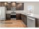 Modern kitchen with stainless steel appliances and dark cabinets at 8836 Waco Ct, Commerce City, CO 80022