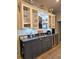 Stylish bar area with custom cabinets, counter seating, and wine storage for elegant entertaining at 83 Wilderness Cornerstone Rd, Evergreen, CO 80439