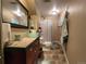 Bathroom featuring a unique glass bowl sink, tiled countertop, and updated shower at 83 Wilderness Cornerstone Rd, Evergreen, CO 80439