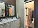 Bathroom with a double vanity, decorative mirrors, and a separate shower area at 83 Wilderness Cornerstone Rd, Evergreen, CO 80439