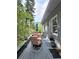 Side deck view with outdoor seating and gorgeous views of the surrounding nature at 83 Wilderness Cornerstone Rd, Evergreen, CO 80439