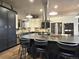 Modern kitchen featuring a large island with seating, stainless steel appliances, and custom cabinetry at 83 Wilderness Cornerstone Rd, Evergreen, CO 80439