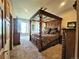 Luxurious main bedroom with a decorative canopy bed and natural light streaming through the windows at 83 Wilderness Cornerstone Rd, Evergreen, CO 80439