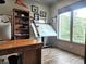 Bright home office with a large window, wooden desk, and built-in bookcase at 83 Wilderness Cornerstone Rd, Evergreen, CO 80439