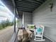 Covered porch with a white rocking chair and bench seating, and a table with a cover at 83 Wilderness Cornerstone Rd, Evergreen, CO 80439