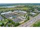 Aerial view reveals commercial area with shopping and restaurants, easy highway access, and proximity to nearby residential area at 7120 S Clay St, Littleton, CO 80120