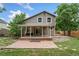 The cozy home features a wooden back porch, a brick patio and a small yard at 7120 S Clay St, Littleton, CO 80120