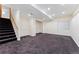 A spacious basement boasts recessed lighting and carpet, offering versatile living space and easy access to stairs at 7120 S Clay St, Littleton, CO 80120