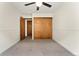 A simple bedroom features a double closet with sliding doors and a neutral color scheme at 7120 S Clay St, Littleton, CO 80120