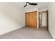 This bedroom features a closet with sliding doors and a door into the bathroom at 7120 S Clay St, Littleton, CO 80120