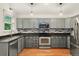 Modern kitchen features stainless steel appliances and ample cabinet space at 7120 S Clay St, Littleton, CO 80120