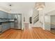 Open-concept kitchen with stainless steel appliances and breakfast bar at 7120 S Clay St, Littleton, CO 80120