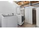 This utilitarian laundry room is equipped with front-load washer and dryer, and white storage at 7120 S Clay St, Littleton, CO 80120