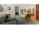 Comfortable living room featuring a fireplace, sofa, and a view of the kitchen at 7120 S Clay St, Littleton, CO 80120