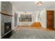 Living room featuring a fireplace, hardwood floors, and a view of the kitchen at 7120 S Clay St, Littleton, CO 80120