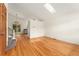 Open living area with hardwood floors, skylight, and access to the kitchen at 7120 S Clay St, Littleton, CO 80120