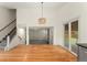 Open-concept living room featuring hardwood floors, staircase, and modern lighting at 7120 S Clay St, Littleton, CO 80120
