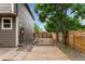 Side yard view with wood walkway, rock bed, and tall wooden fence at 7120 S Clay St, Littleton, CO 80120
