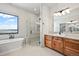 Elegant bathroom with double vanity, soaking tub, and walk-in shower at 5320 Dual Rey Pt, Sedalia, CO 80135