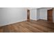 Spacious bedroom with hardwood floors and access to another room at 5320 Dual Rey Pt, Sedalia, CO 80135