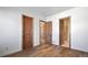 Bedroom with hardwood floors and access to bathroom at 5320 Dual Rey Pt, Sedalia, CO 80135