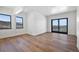 Spacious bedroom with hardwood floors and sliding doors to deck at 5320 Dual Rey Pt, Sedalia, CO 80135