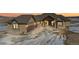 Stunning two-story house with a three-car garage at dusk at 5320 Dual Rey Pt, Sedalia, CO 80135
