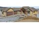 Two-story house with a three-car garage and a stone facade at 5320 Dual Rey Pt, Sedalia, CO 80135