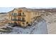 Tan three story house with multiple balconies and decks at 5320 Dual Rey Pt, Sedalia, CO 80135