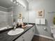 Bright bathroom features a double vanity, a large mirror and neutral finishes, creating a clean space at 7498 S Alkire St # 202, Littleton, CO 80127