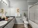 Bathroom with double vanity, framed art, and shower/tub offers a practical, relaxing space at 7498 S Alkire St # 202, Littleton, CO 80127