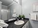 Updated bathroom features a double vanity with stone countertop, enhancing functionality and appeal at 7498 S Alkire St # 202, Littleton, CO 80127