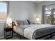 Comfortable bedroom features large window, neutral colors, and cozy bedding for relaxation at 7498 S Alkire St # 202, Littleton, CO 80127