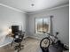 Versatile bedroom with a desk, large window, and neutral finishes, perfect for work/exercise at 7498 S Alkire St # 202, Littleton, CO 80127