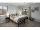 Cozy bedroom with neutral colors, comfortable bed, and natural light from the windows at 7498 S Alkire St # 202, Littleton, CO 80127