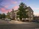 Charming condo building with stone accents and well-maintained landscaping with reserved parking at 7498 S Alkire St # 202, Littleton, CO 80127