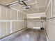 An empty garage with concrete floors, unfinished walls and an automatic door opener at 7498 S Alkire St # 202, Littleton, CO 80127