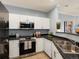 Well-equipped kitchen with stainless steel appliances, granite countertops, and ample storage space at 7498 S Alkire St # 202, Littleton, CO 80127