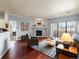 Comfortable living room featuring a cozy fireplace, hardwood floors, and sliding glass doors to a balcony at 7498 S Alkire St # 202, Littleton, CO 80127
