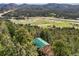A home sits amongst trees with a scenic mountain view at 8386 S Davco Dr, Morrison, CO 80465