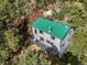 Stunning mountain house featuring a green roof, gray siding, and a wrap-around deck at 8386 S Davco Dr, Morrison, CO 80465