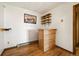 A charming bar area with custom wood finishes, shelving, and hardwood floors at 8386 S Davco Dr, Morrison, CO 80465