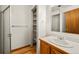 Bright bathroom featuring a vanity and a closet with built-in shelves at 8386 S Davco Dr, Morrison, CO 80465