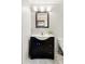 Bathroom featuring a dark vanity with light countertop and a square mirror at 8386 S Davco Dr, Morrison, CO 80465