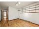 Bright bedroom featuring wood floors, built-in shelves and scenic views at 8386 S Davco Dr, Morrison, CO 80465
