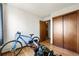 Bedroom featuring hardwood floors, a closet, and a view into the hallway at 8386 S Davco Dr, Morrison, CO 80465
