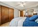 Bedroom with hardwood floors, large closet, dresser with mirror, and ensuite bathroom at 8386 S Davco Dr, Morrison, CO 80465