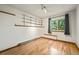 Bright bedroom featuring wood floors, large windows with scenic view, and built-in shelves at 8386 S Davco Dr, Morrison, CO 80465
